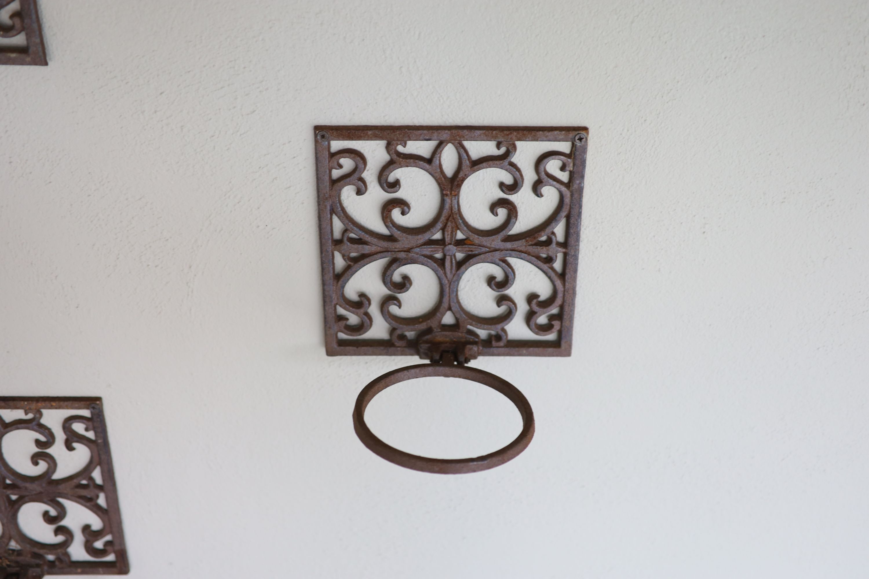 A set of eighteen wrought iron wall mounted folding plant pot holders, width 19.5cm